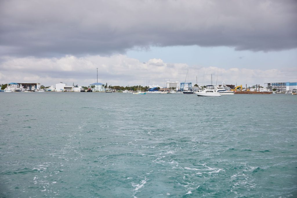 Clouds over the water near boats, check the weather before boating concept. 