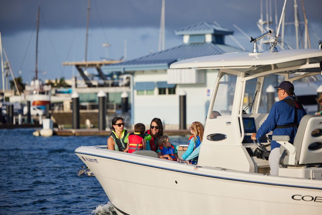 A man drives a boat carrying people, safe boating concept. 