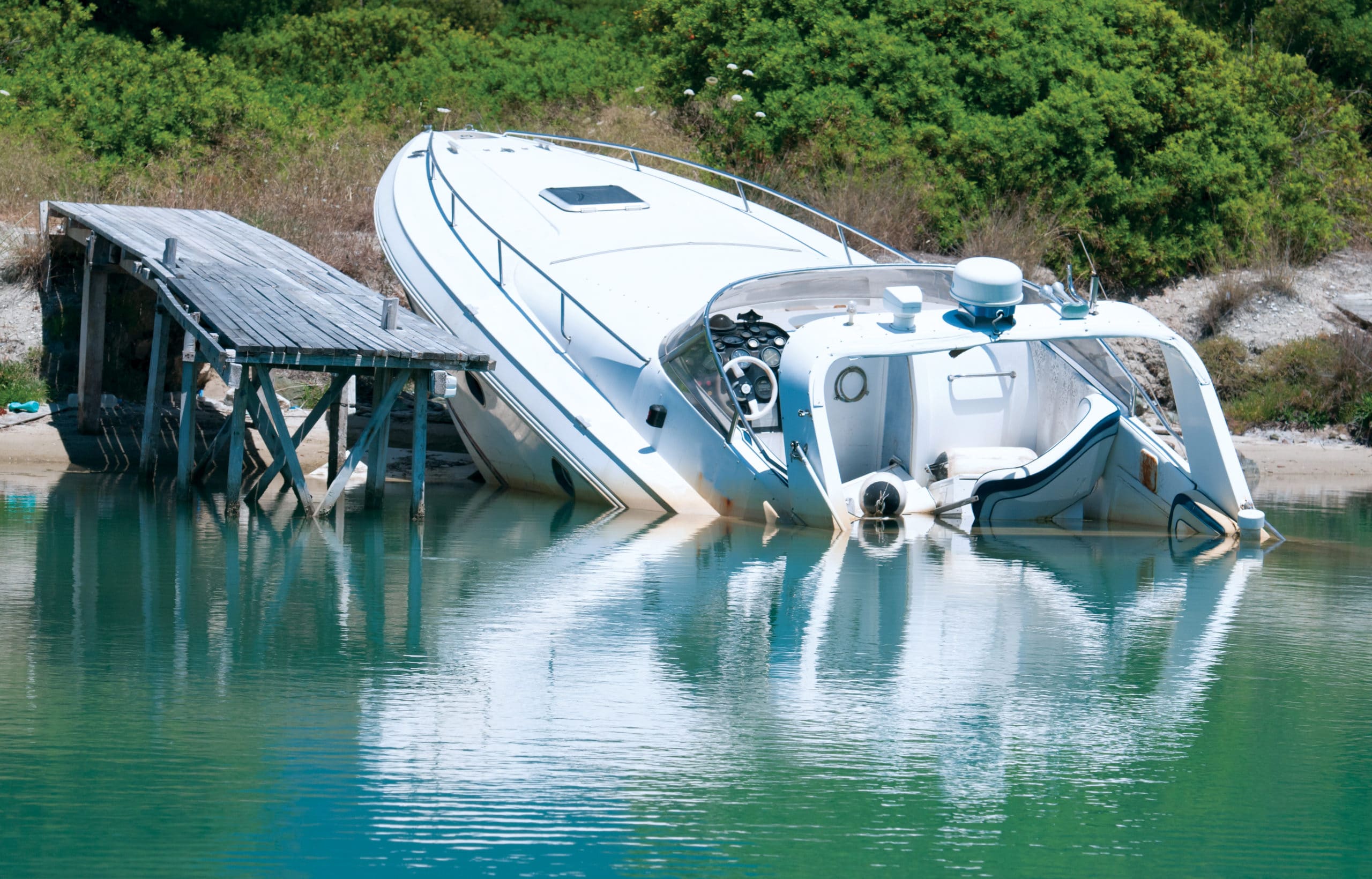 A boat on the shore after an accident, understanding Vermont boating laws concept. 