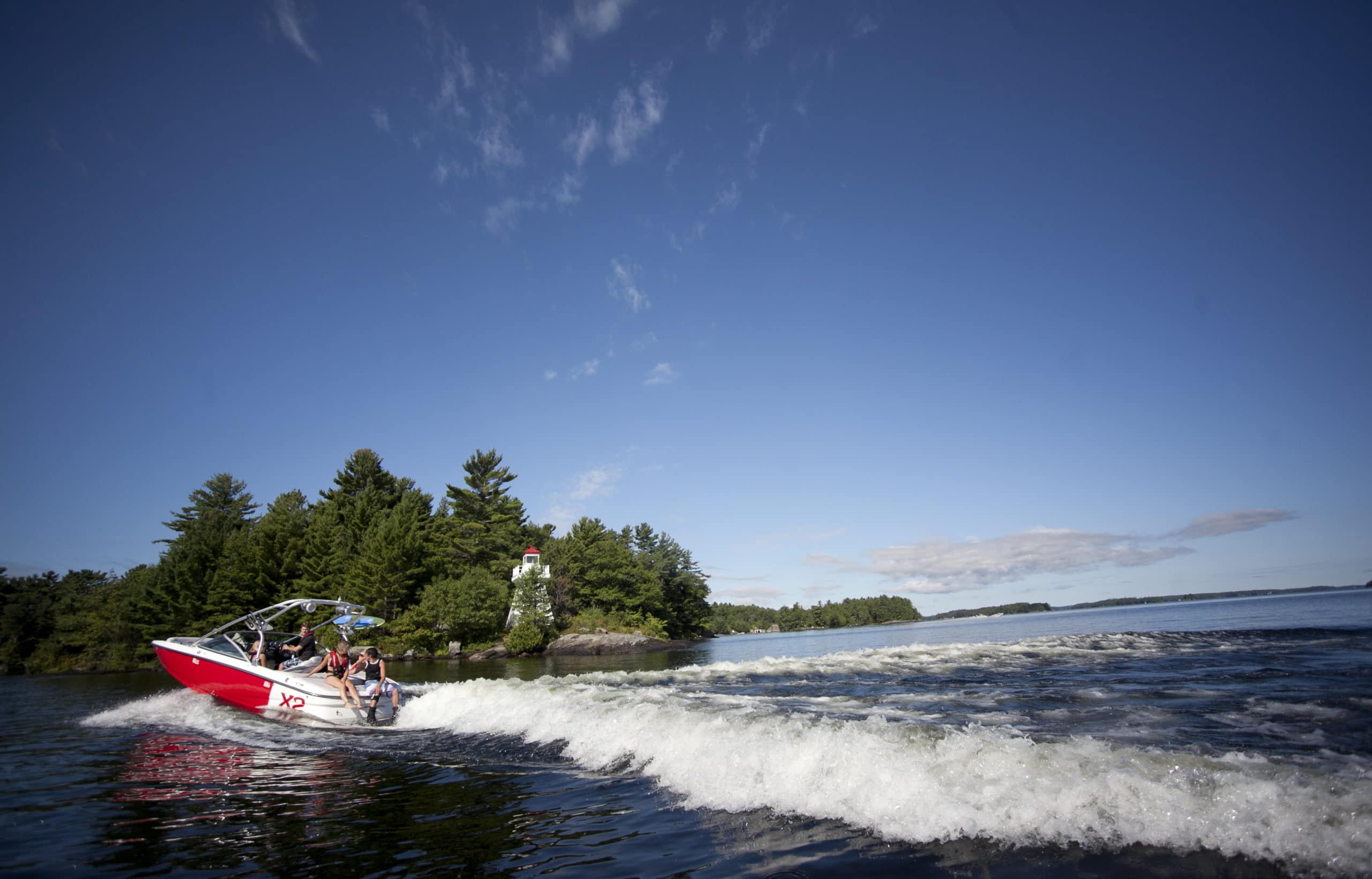 A boat making a wake on the water, follow North Dakota boating laws concept. 