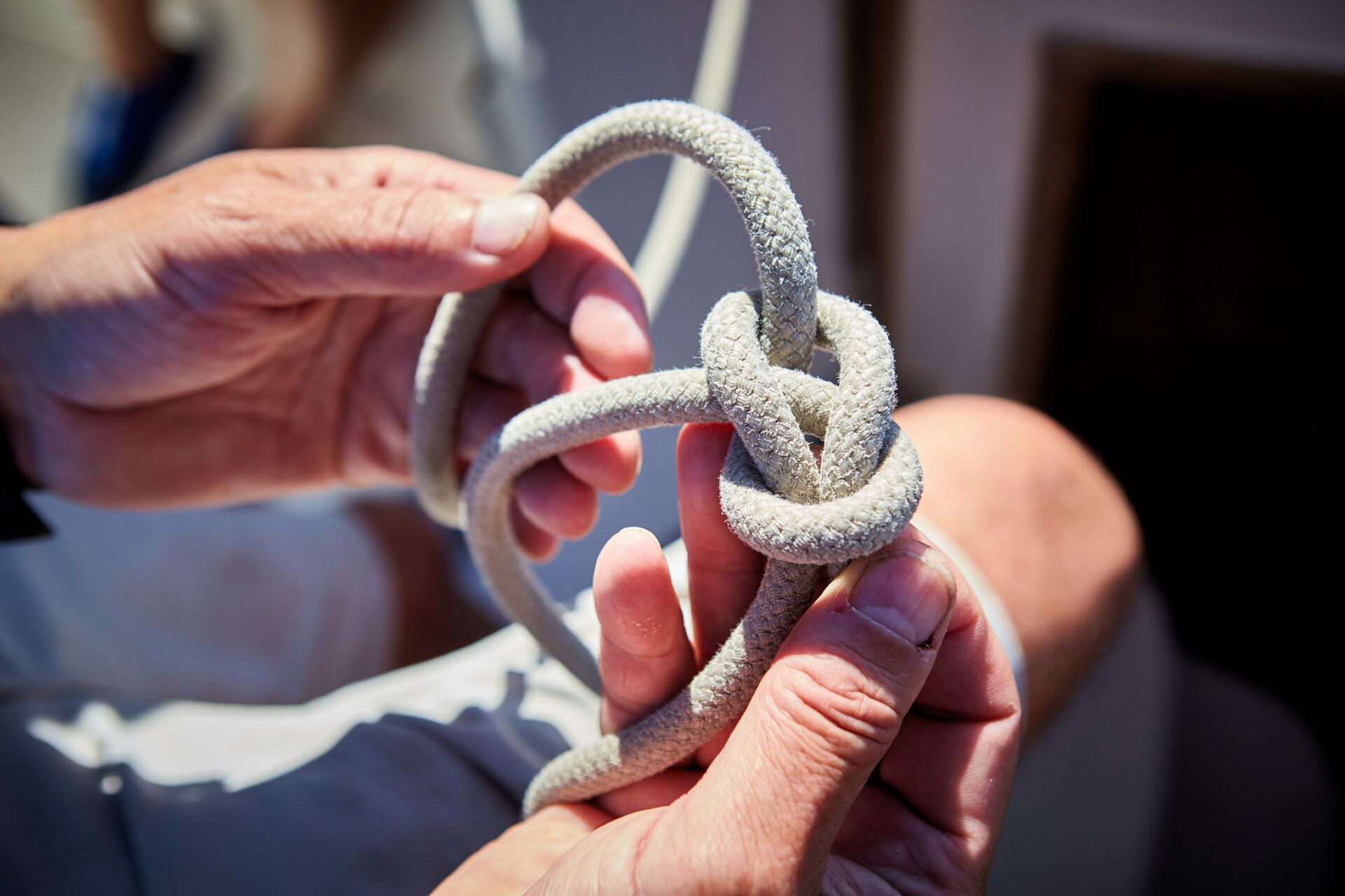 Hand tying a knot, nautical knots concept. 