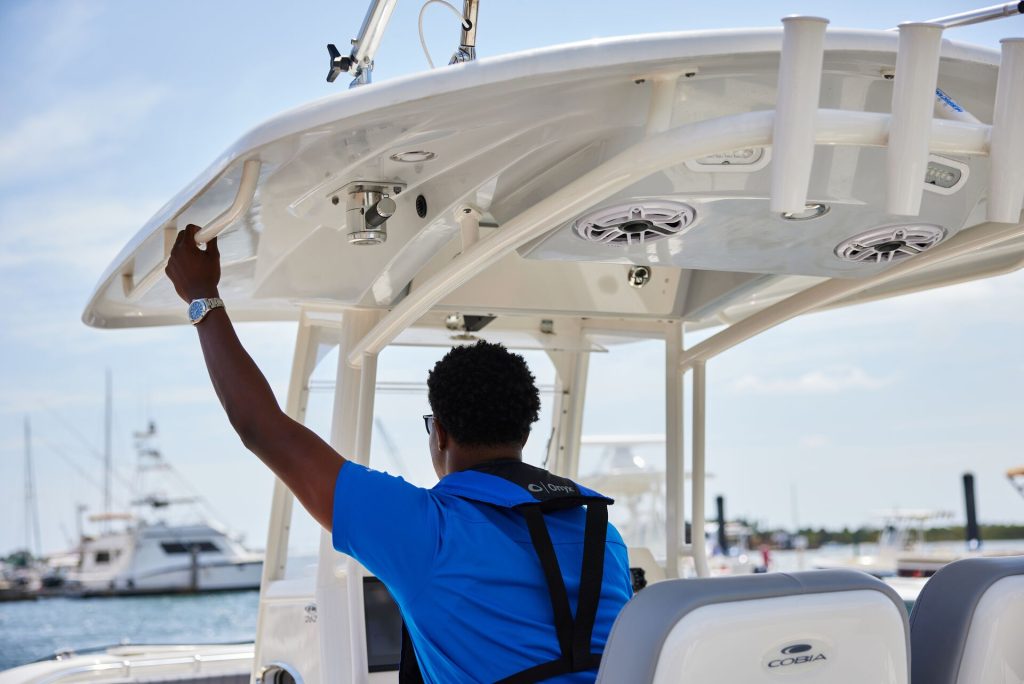 A man driving a boat, license to drive a boat in Ontario concept. 