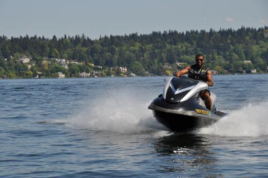 A man enjoying a PWC (personal watercraft) on a lake. 