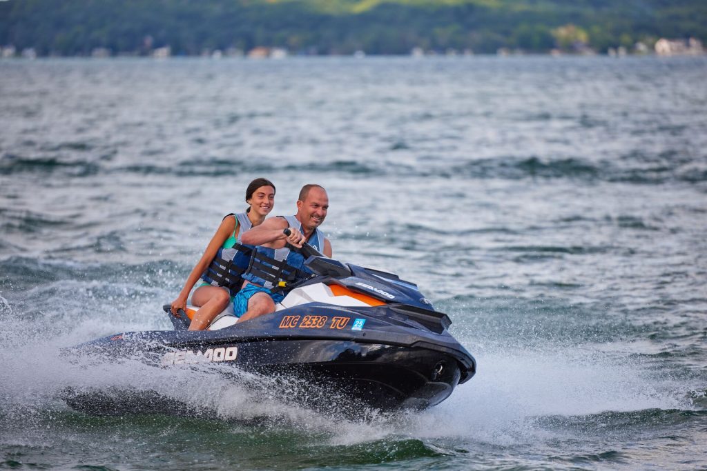 A man and girl on a personal watercraft (PWC), New York boating concept. 