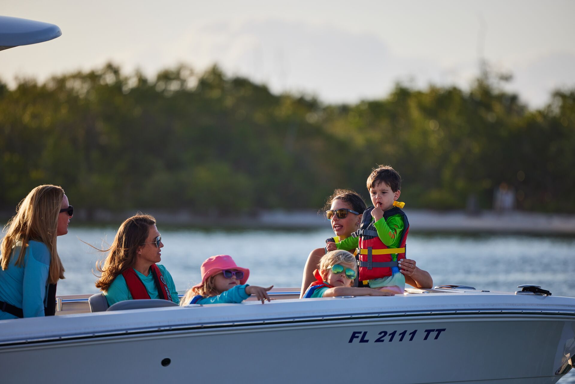 Women and children on a boat while wearing life jackets, boating in West Virginia concept. 