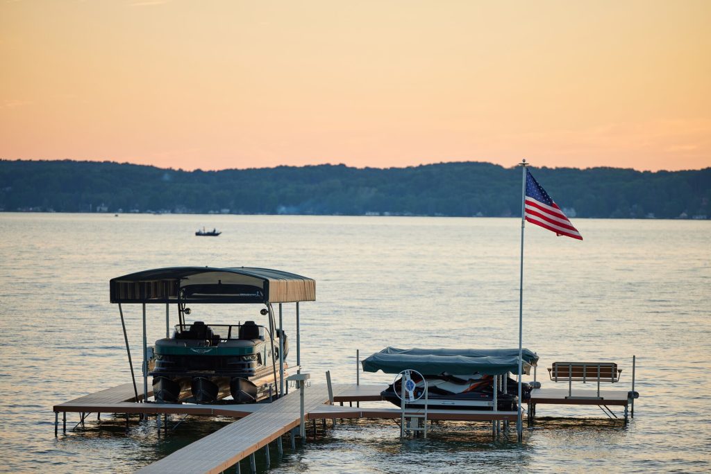 A boat at the dock near a U.S. flag, New York boat registration concept. 