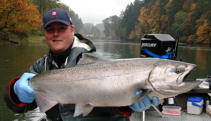 A man holds a fish while on a boat.