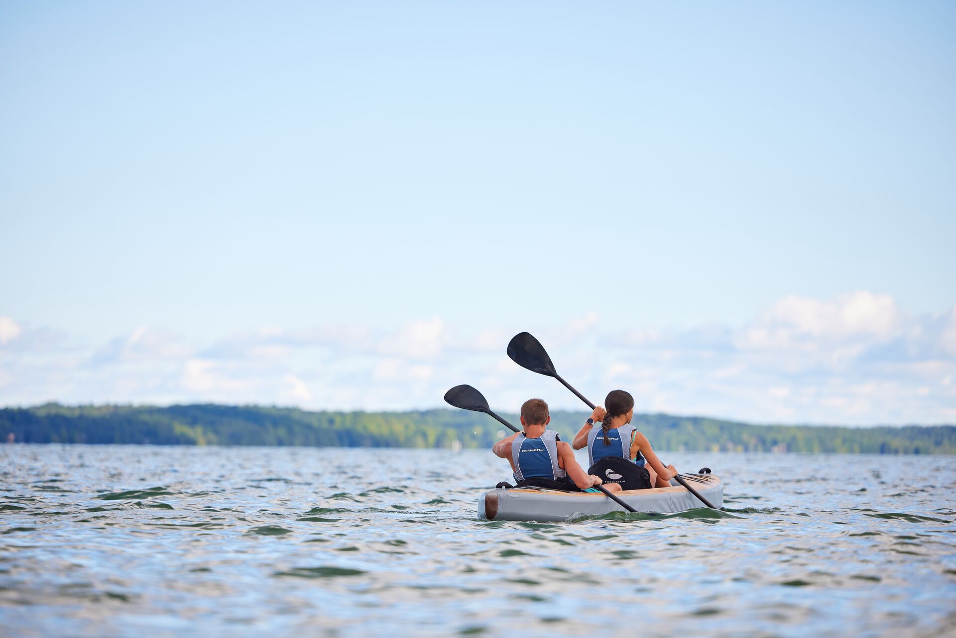 Back view of two people on a kayak, boating in North Dakota concept. 