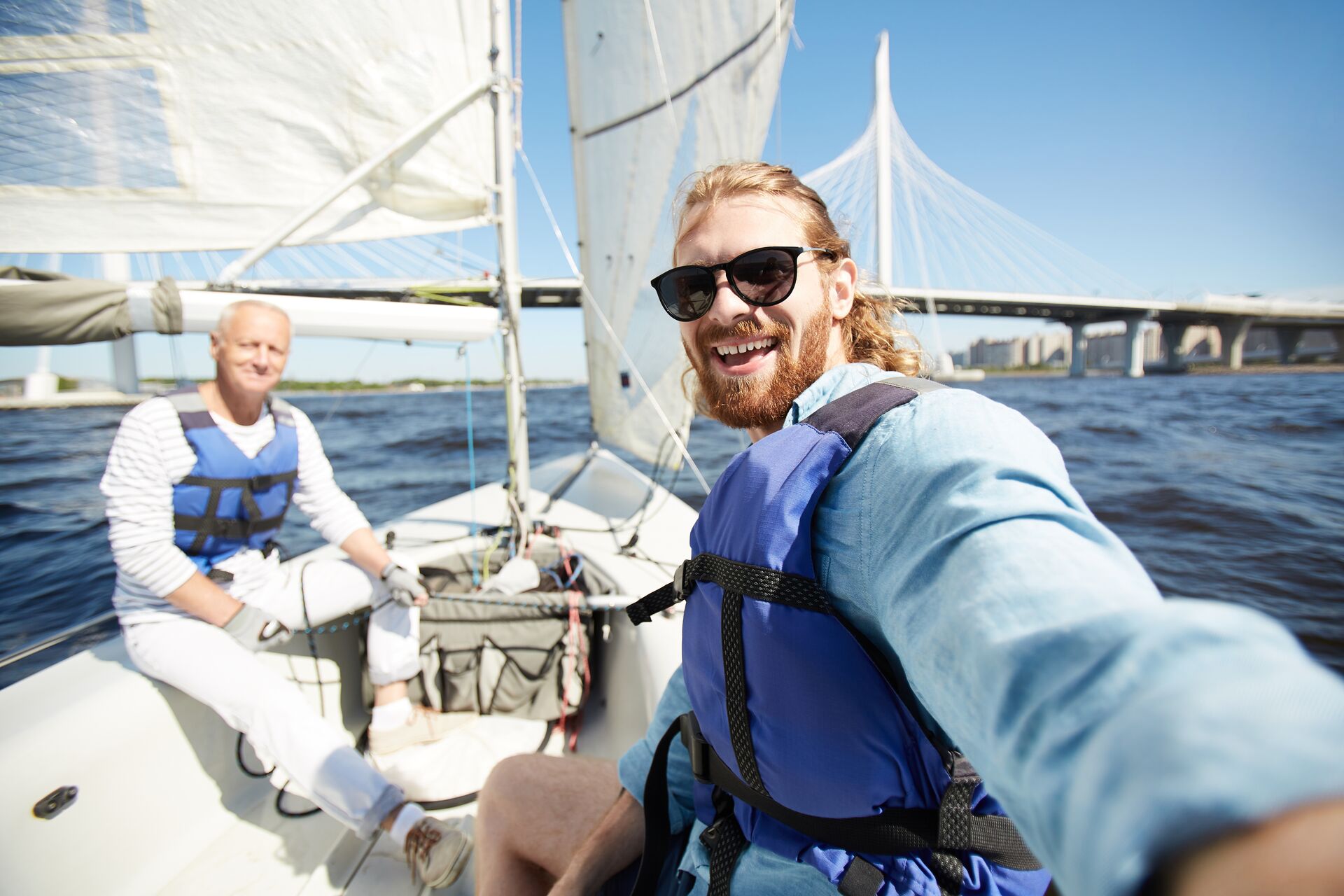 Two men on a sail boat, boating in Virginia concept. 