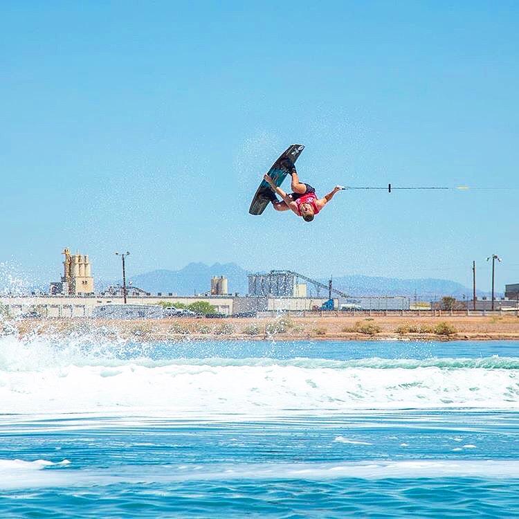 A person doing a flip on a wakeboard. 