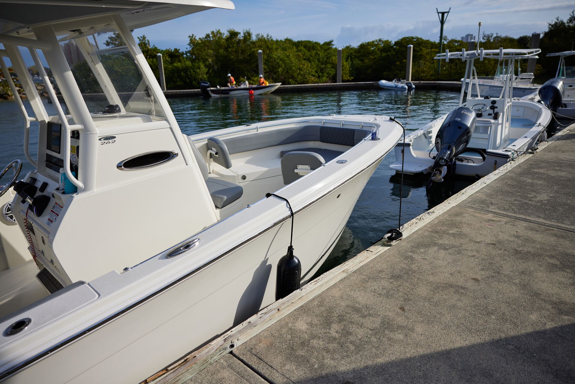 Boats lined up at a dock, earning boating badges of honour concept. 