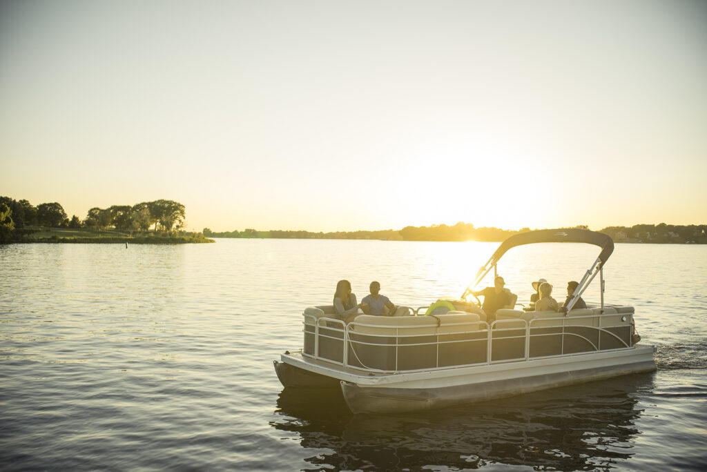 People on an anchored pontoon boat. 