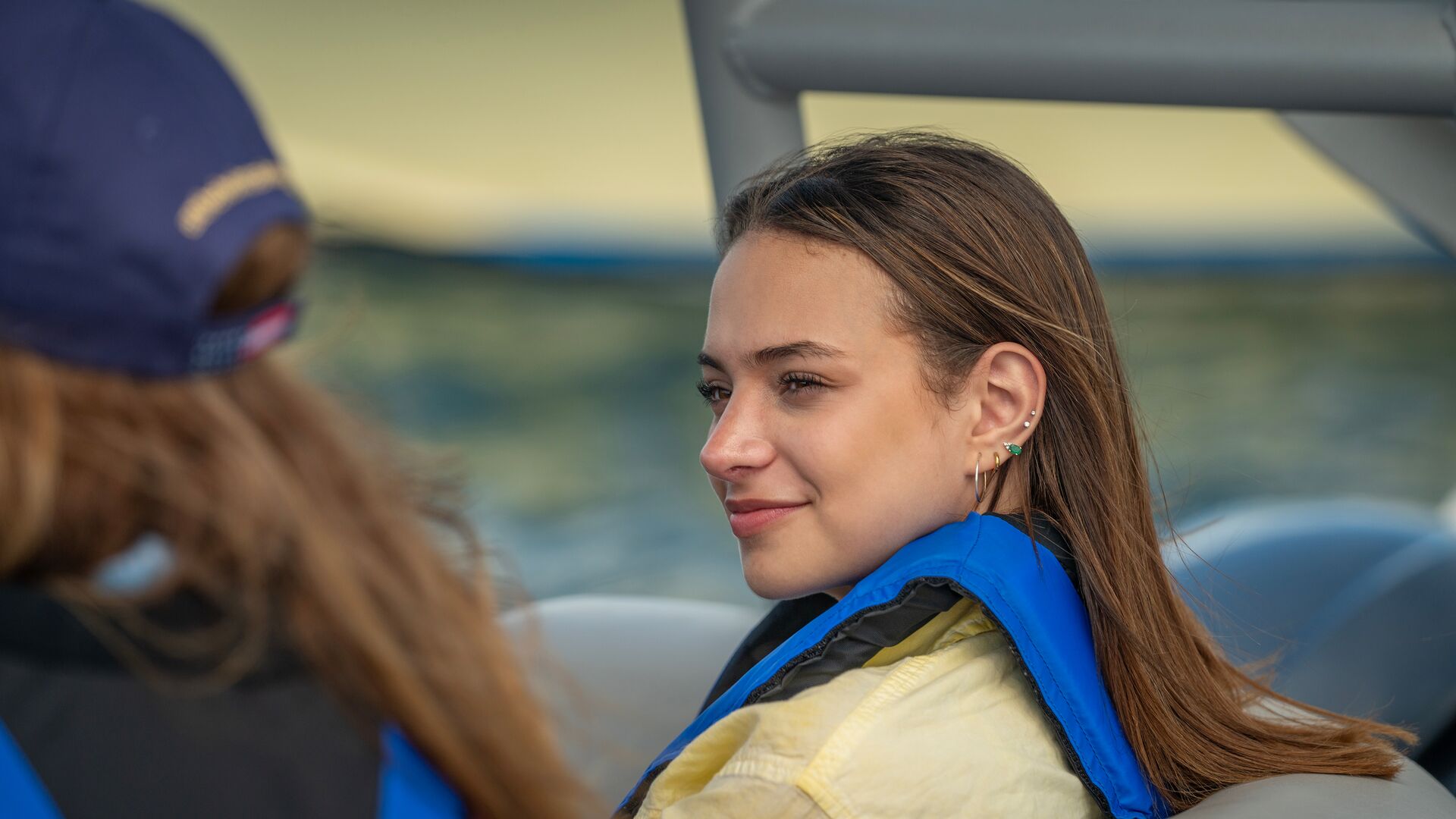 A girl in a life jacket on a boat, boating in Nova Scotia concept. 