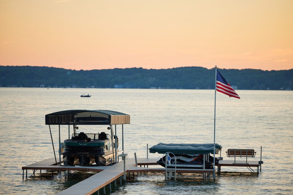 A boat at the dock near a U.S. flag, New York boat registration concept.