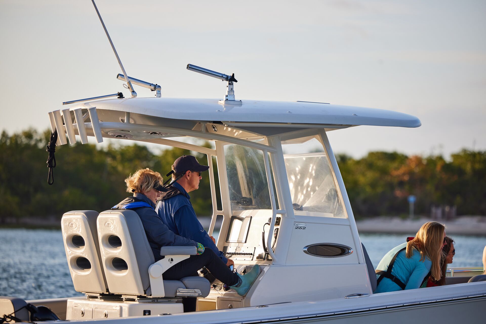 A boat operator with people on the boat on the water, boating tour concept.
