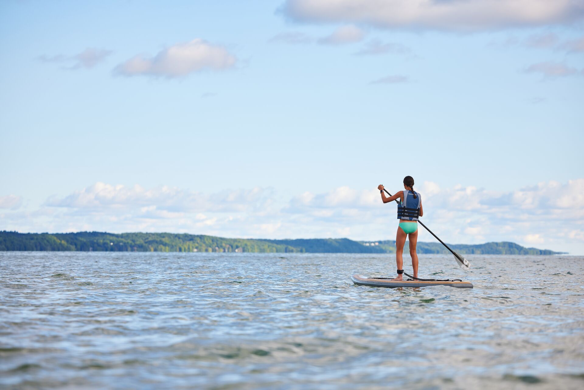 A girl on a paddleboard, water activities and boating in Nevada concept.