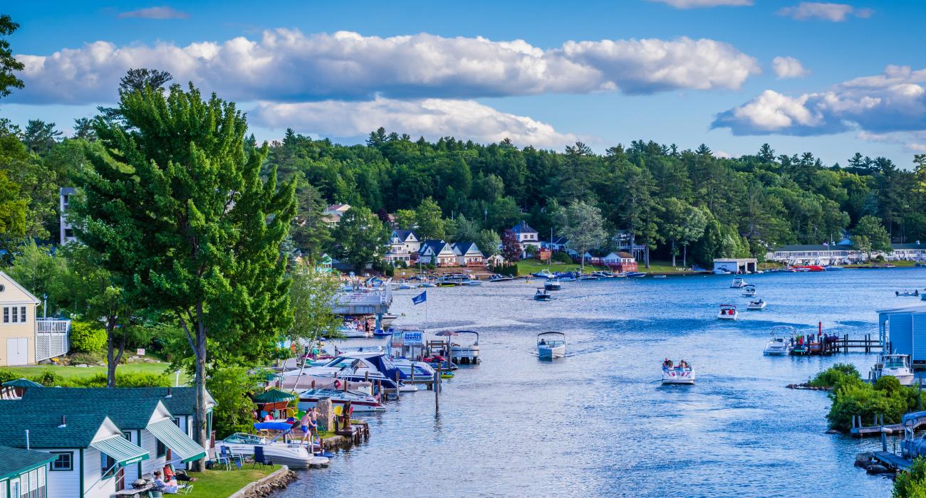 Boats on the water near land, New Hampshire boating laws concept.