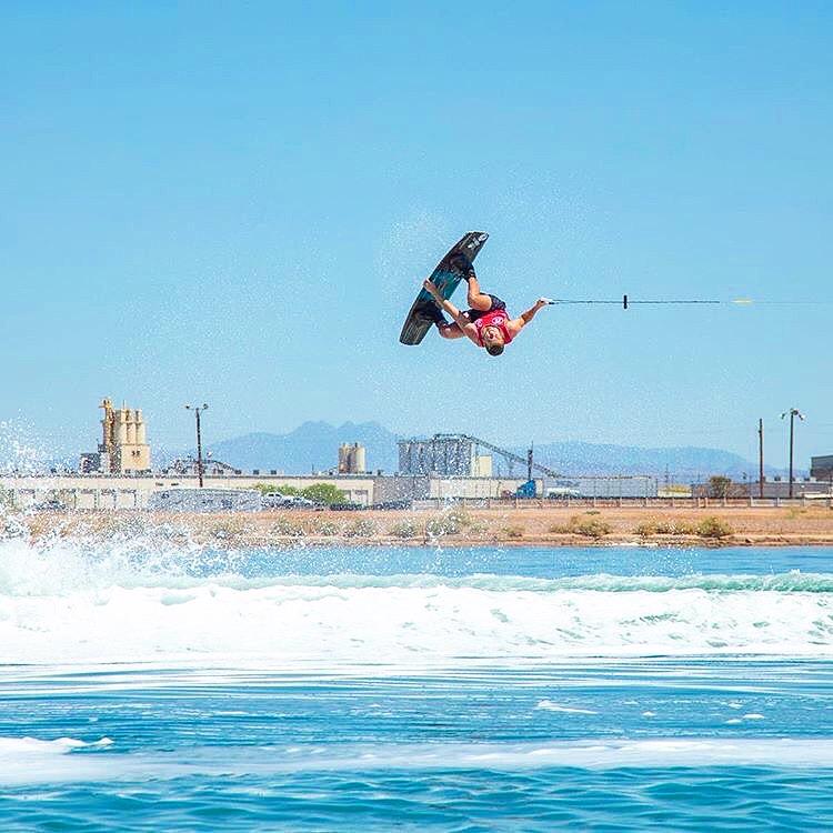 A person doing a flip on a wakeboard.