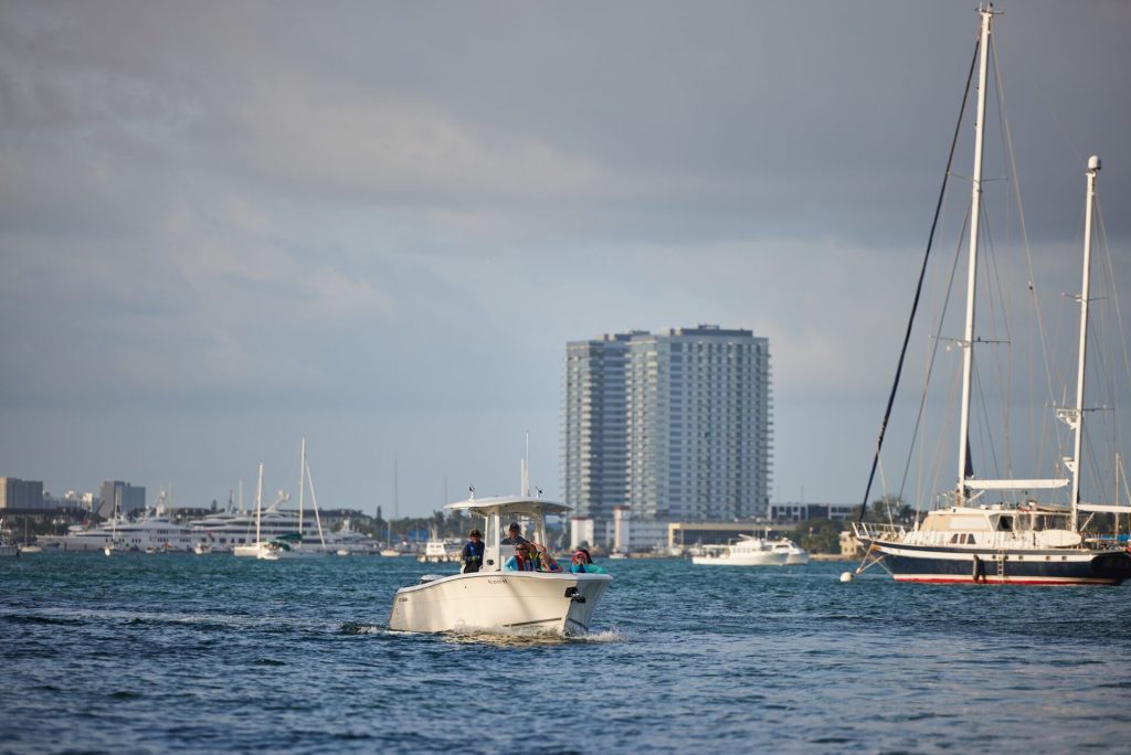 A boat navigating near a sailboat on the water. 